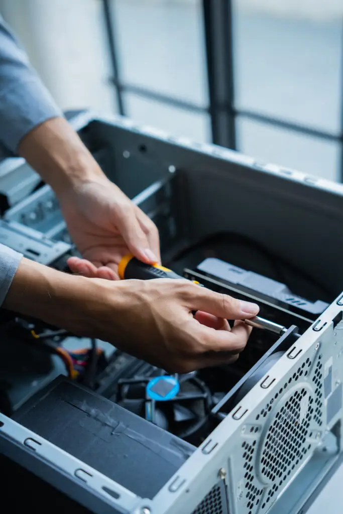 Technician repairing internal components of a desktop computer