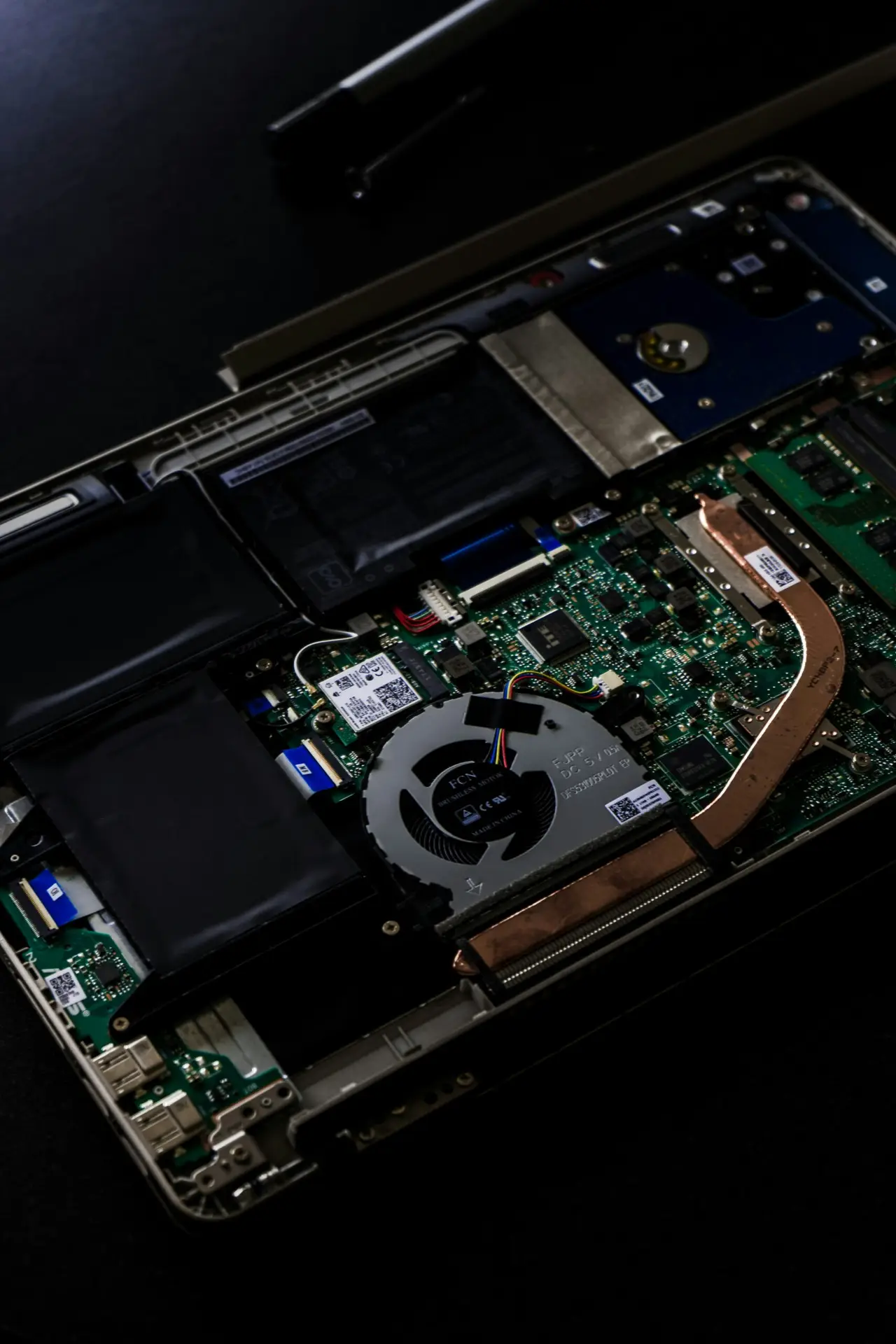 Open laptop showing internal components for computer repair