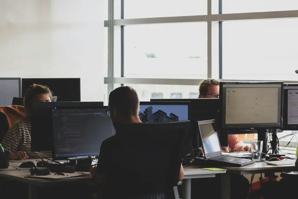 Employees working at computers in a modern office network