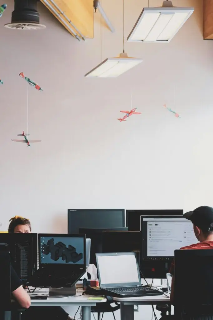 IT professionals working at computers in a modern office