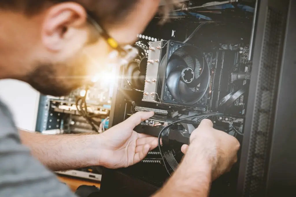 Technician repairing internal components of a desktop computer