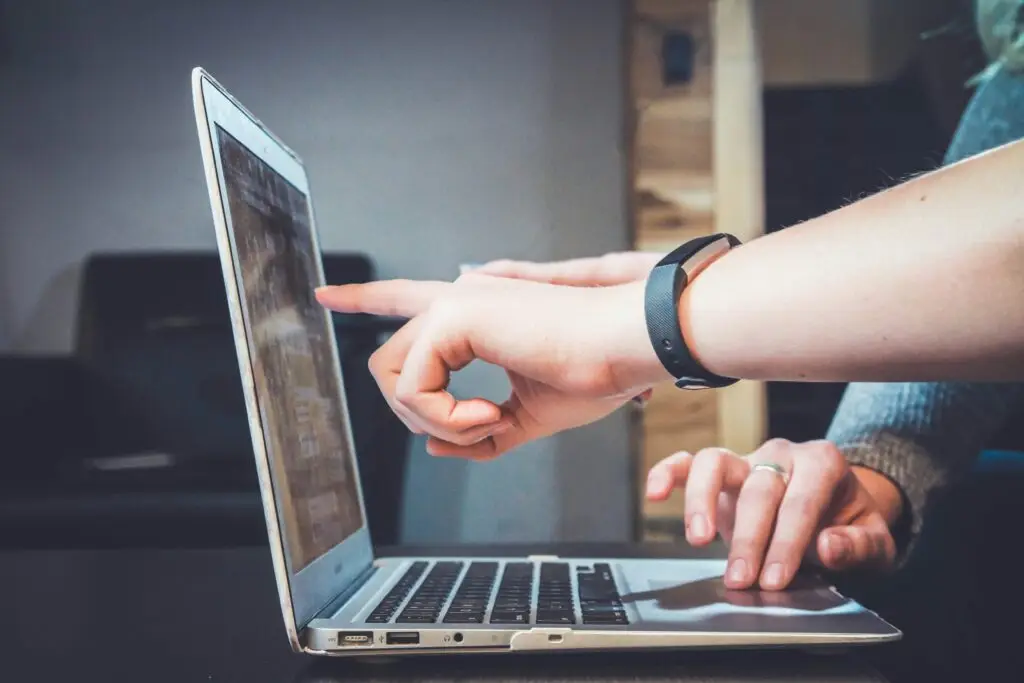 IT support professional helping a user with a laptop