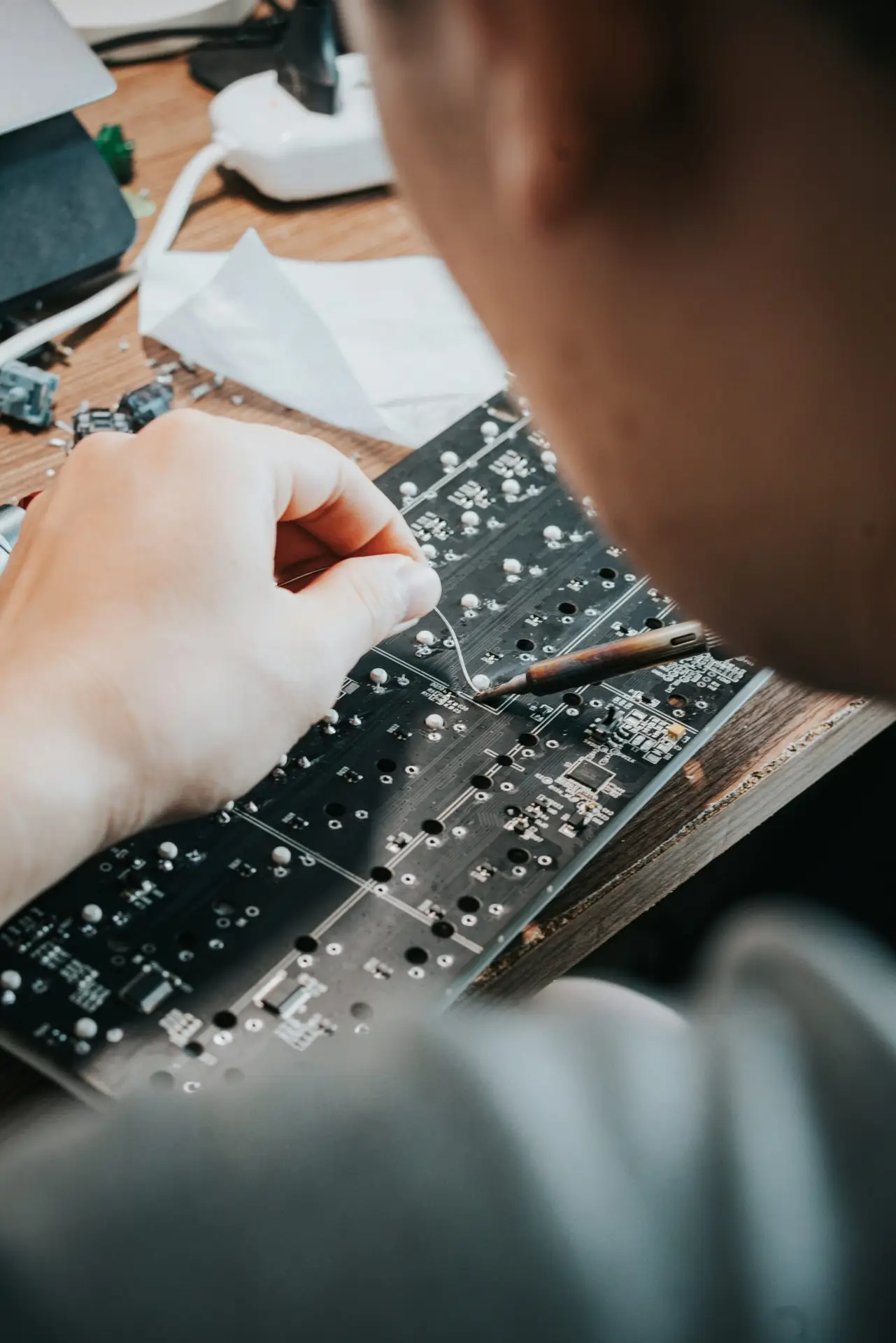 Technician soldering and repairing a computer circuit board