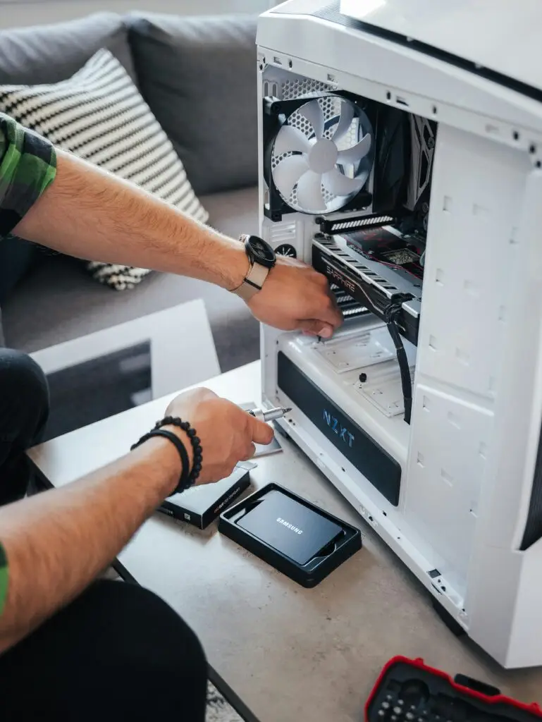 Technician repairing internal components of a desktop computer